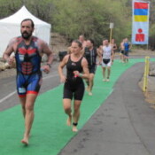 Athletes make their way up the hill from the swim to their patiently awaiting bikes